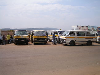 A row of minibus share taxis waiting to depart  in Kigali, Rwanda