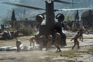 Pakistani Soldiers carry tents away from a U.S. Army CH-47 Chinook helicopter here October 19. The United States is taking part in the multinational effort to provide humanitarian assistance and support to Pakistan and parts of India and Afghanistan following the devastating October 8 earthquake.
