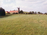 Windmills, antique (pictured) and modern, accent the gently rolling meadowlands of Denmark.