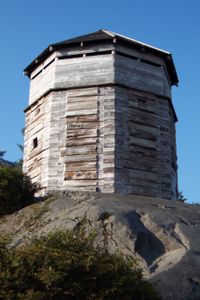 A replica of Russian Block House #1 (one of three watchtowers that guarded the stockade walls at Old Sitka) as constructed by the National Park Service in 1962.
