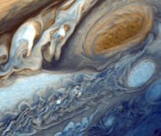 False-colour detail of Jupiter's atmosphere, imaged by Voyager 1, showing the Great Red Spot and a passing white oval.