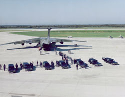 The Challenger crewmember remains being transferred from 7 hearse vehicles to a MAC C-141 transport plane at the SLF for transport to Dover Air Force Base, Delaware.