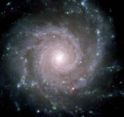 Spiral Galaxy M74 presents a face-on view of its spiral arms. It contains about 100 billion stars, 30 million light-years away toward the constellation Pisces.