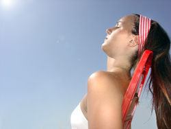 Sunbathing is popular for the cosmetic benefits of a sun tan, although there are also risks of cellular damage to the skin.