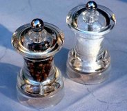 Salt and pepper grinders filled with the seasonings