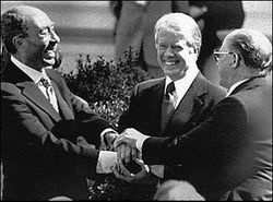 Celebrating the signing of the Camp David Accords in the White House Rose Garden: Menachem Begin (right), Jimmy Carter (center), Anwar Sadat (left)
